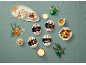 Individual coffee, hazelnut, peach, vanilla, banana, caramel, and macadamia nut ice creams in a festive setting.