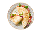 Piadina with ham, mozzarella, tomato, zucchini, and arugula on a striped plate.