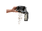 Hand emptying dust and dirt from a vacuum cleaner container.