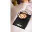 Kitchen scale with a bowl of almond flakes on a white table.