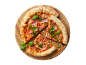 Pizza with ham, pesto, and basil on a wooden board, with two slices alongside.