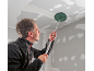 Man sanding a ceiling with a long-handled sander.