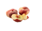Two whole and two cut flat peaches on a black background.