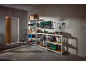 Garage or workshop with shelving units, tools, storage boxes, and a vacuum cleaner.