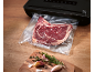 Vacuum-sealed beef with a vacuum sealer machine and fresh herbs.
