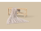 Wooden bench with a woven seat and a beige knitted throw falling to the floor.