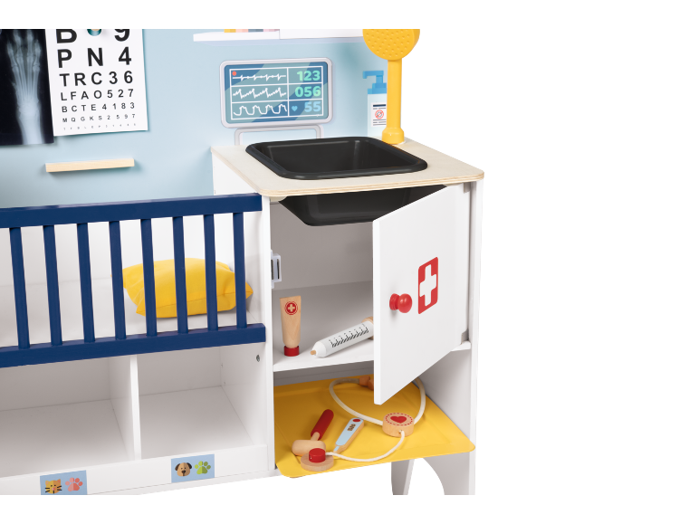 Children's wooden pet hospital play set with medical tools and a crib.