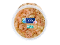 Shrimp in garlic-herb oil in a round plastic container.