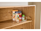 Clear container with pasta and spices on a wooden shelf.
