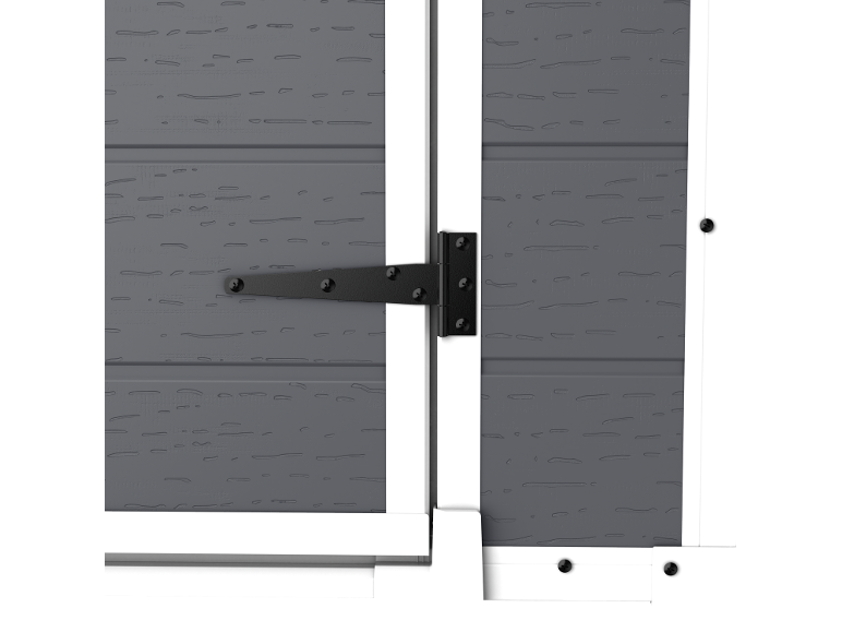 Close-up of a gray barn door with a white frame and a black hinge.
