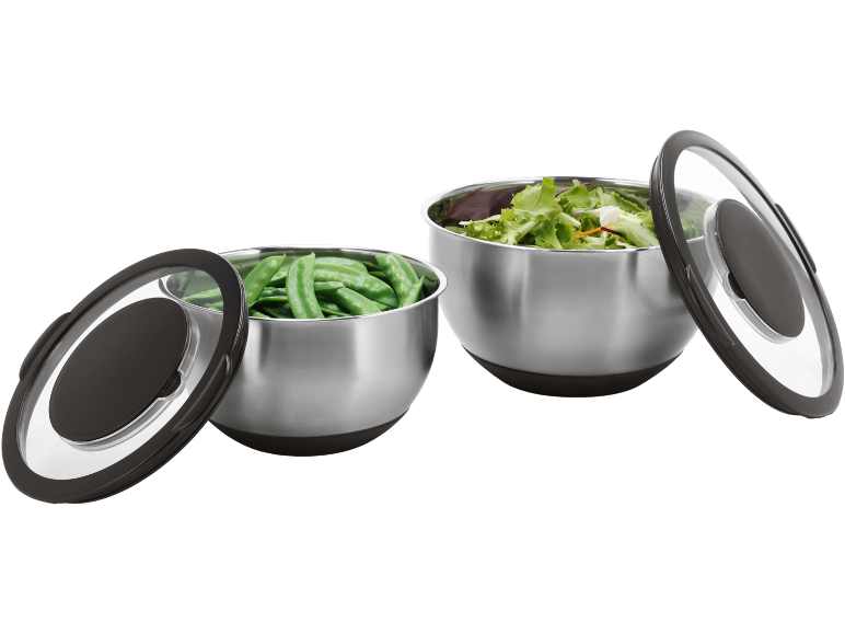 Two stainless steel bowls with lids, one with peas and the other with lettuce.