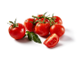 Fresh red tomatoes on the vine and one sliced tomato with leaves.