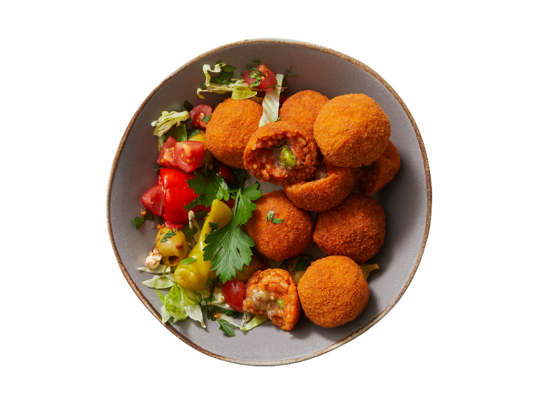 Arancini with fresh tomato, lettuce, and olive salad in a bowl.