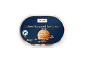 Coffee flavoured ice cream tub with a scoop of ice cream and coffee beans.
