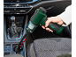 Green handheld vacuum cleaner cleaning a car interior