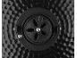 Black, circular ventilation valve on a dimpled metal surface.