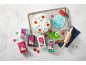 Cake decorated with colourful ready-to-roll icing, with more icing packs and tools.