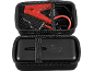Black case with red car jump starter cables and a portable charger.