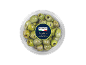 Green Nocellara olives with rosemary and thyme in a transparent container.