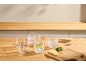 Glasses with water, lemon, and mint on a wooden table.
