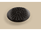 Black round shower head with small nozzles on a beige background