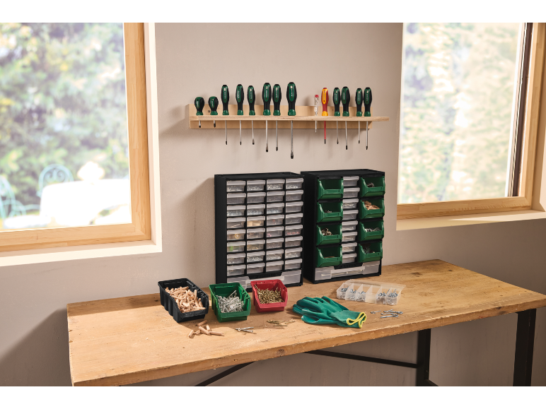 Workbench with screwdrivers, storage boxes, and work gloves for DIY.