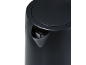 Close-up of a black electric kettle with a spout and lid.