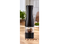 Black pepper grinder with a clear section filled with mixed peppercorns on a wooden surface.