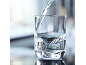 Transparent glass being filled with fresh, clear water.