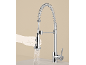 Chrome kitchen faucet with pull-out spray head and spring, a hand holds the spray head.
