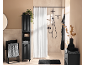 Modern black bathroom furniture set with shower, towels, and decorative elements.