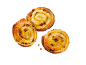 Three golden, shiny raisin swirls on a black background.