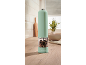 Mint green electric pepper mill on a wooden kitchen countertop.
