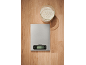 Kitchen scale and bowl of flour on a wooden countertop.