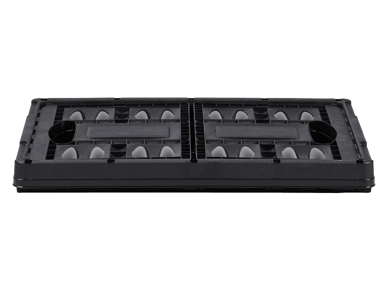 Folded black plastic storage crate on a black background.