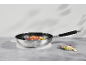 Frying pan with chicken and cauliflower on a concrete table