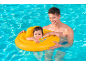 Father and baby in pool, baby in a yellow swim float.