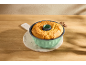 Freshly baked cake in a green bundt pan on a wooden table.