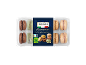 Packaged macarons with chocolate, pistachio, espresso, lemon, salted caramel, and tiramisu flavors.