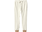 Cream fleece sweatpants with a drawstring waist and brown ribbed cuffs.
