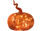 Illuminated orange glass pumpkin with a twisted stem on a black background.