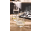 Water carafe and glasses with lemon water on a table.