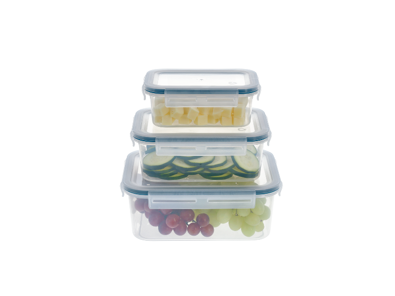 Stacked food containers with cheese cubes, cucumber slices, and grapes.