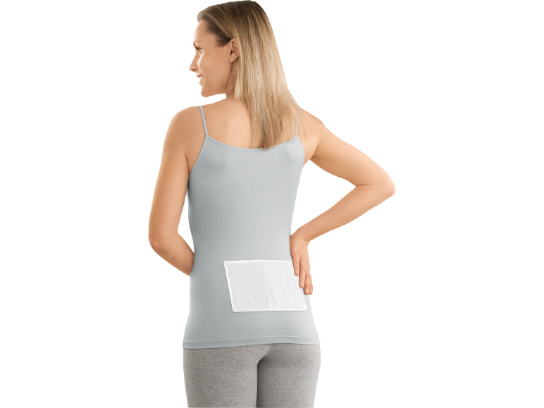 Woman with a pain relief patch on her lower back
