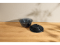 Set of grey mixing bowls and black lids on a wooden table.