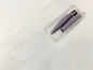 Two purple pencil extenders and a metal screw in a clear plastic case.