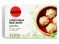 Box of vegetable bao buns with a steamer basket of buns on the right.