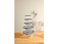 Set of glass bowls with grey lids, stacked on a wooden table.