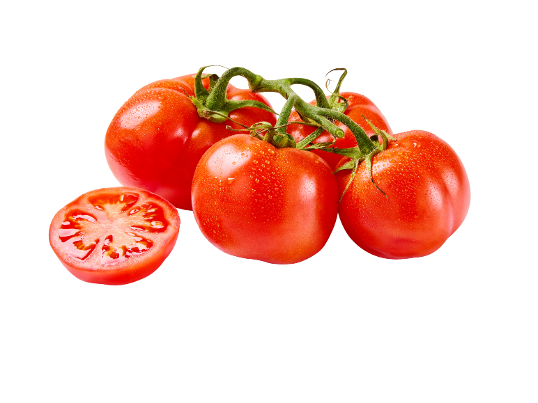 Fresh red tomatoes on the vine, one sliced in half, with water droplets.