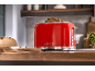 Red toaster with toast and bread on a wooden kitchen counter.